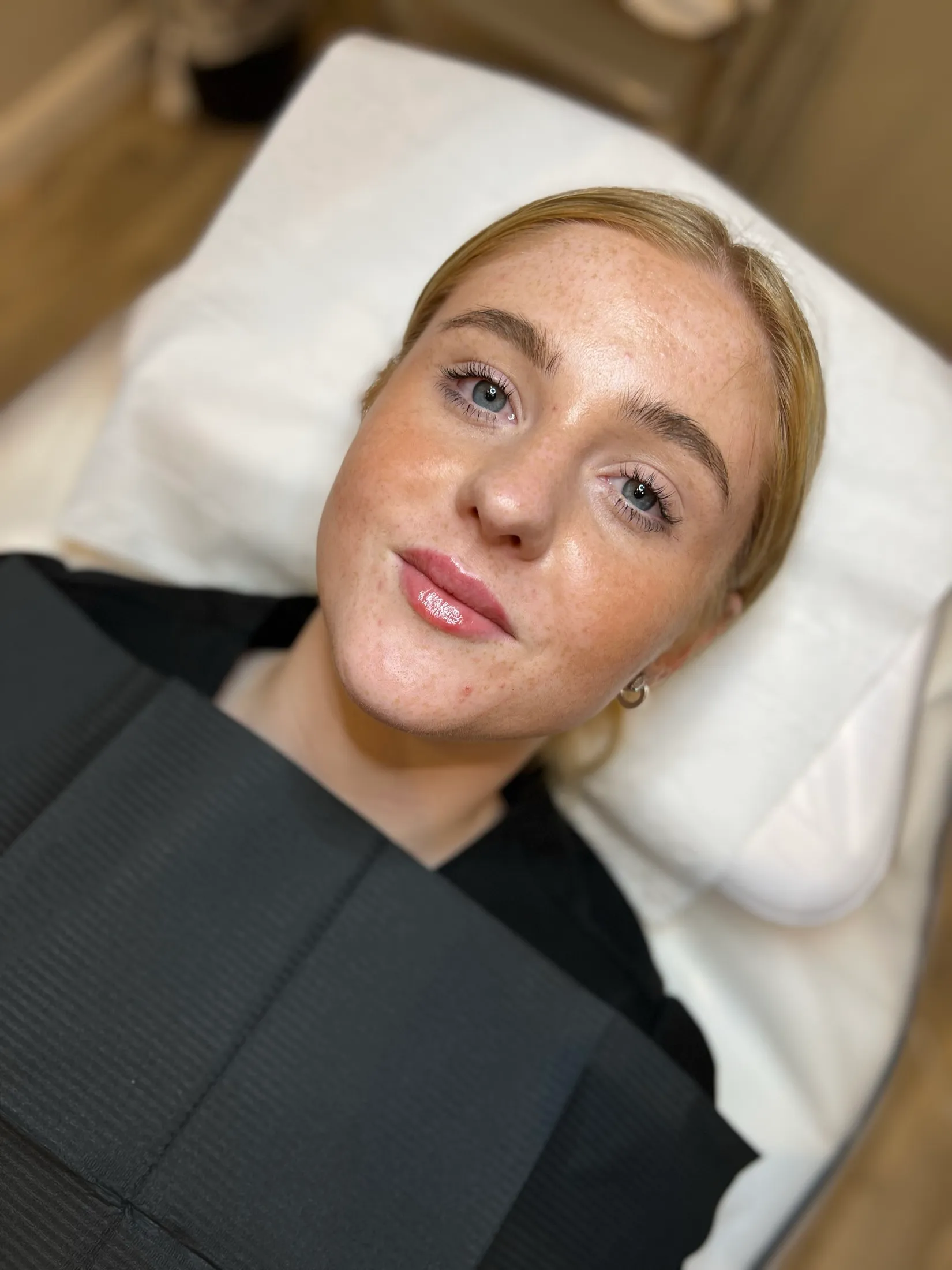 A Pro Level Beauty client relaxing on the treatment bed